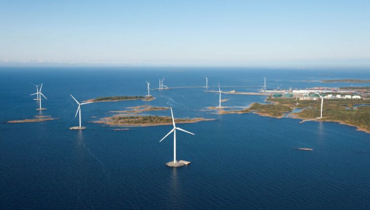 Offshore wind park on artificial islands, few islands, still sea and sunny weather